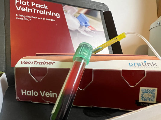 Halo Vein vein training device with a box labeled 'VeinTrainer' and 'prelink'. VeinTrain flat-pack vein simulator for phlebotomy and cannulation training